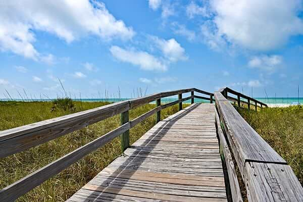 Wooden Beach Boardwalk leading to the white sandy Anna Maria Island, Florida