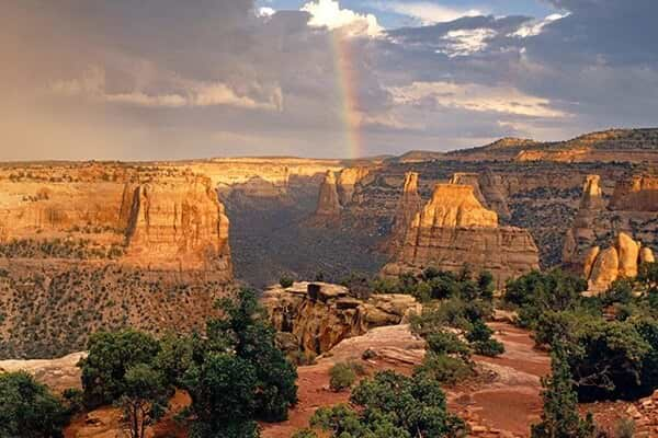 canyon view of rainbow on a sun setting evening