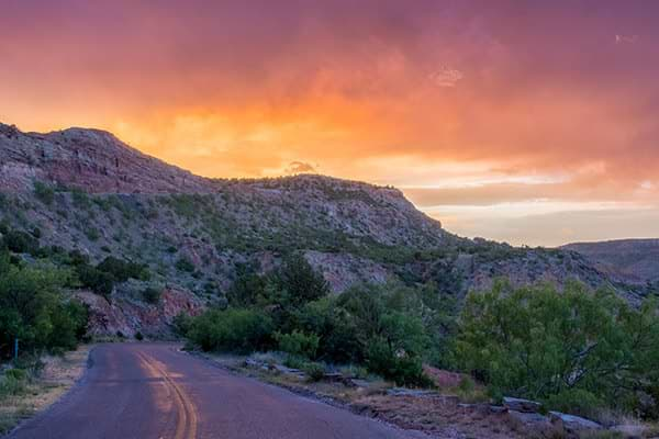 sun setting view of the mountains in palo duro state park