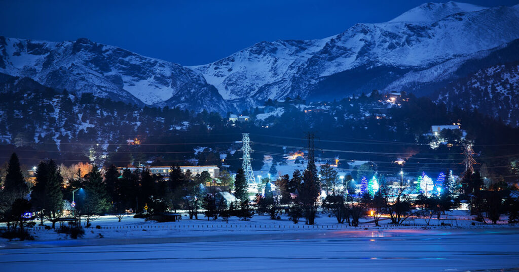 Estes Park campground with Rocky Mountain National Park peaks in the background.
