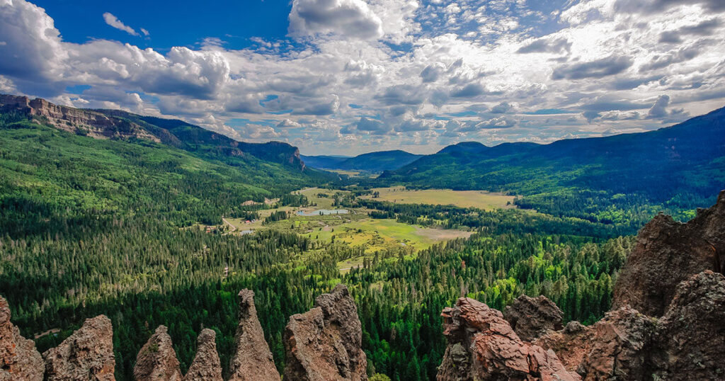 Pagosa Springs campground with San Juan Mountains and hot springs in the background.