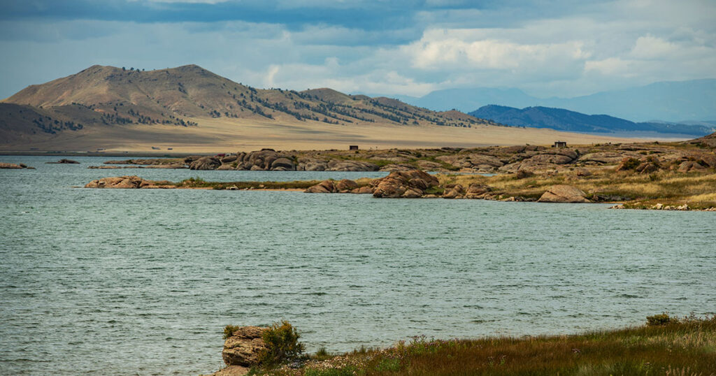 Eleven Mile State Park campground with reservoir and fishing boats in the background.