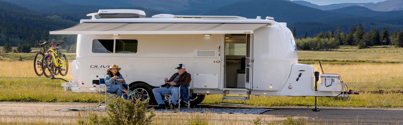 Ttravel trailer with comfortable sleeping and living spaces, perfect for couples.