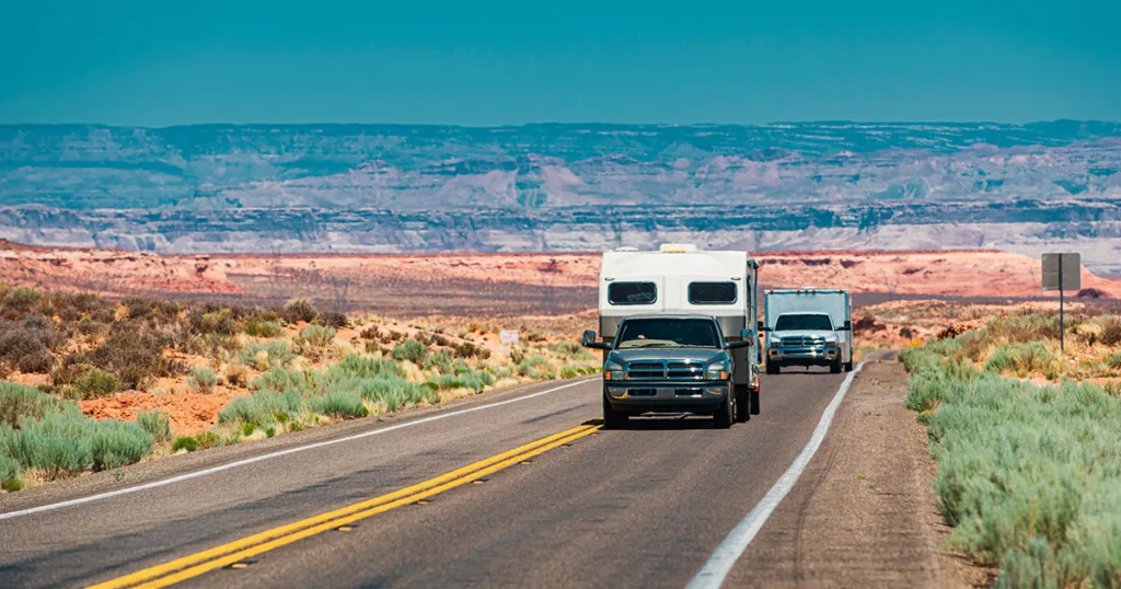 Outside the RV windows, you can catch a glimpse of a scenic road, hinting at the couple's adventurous spirit and their commitment to staying comfortable and safe while on the road.