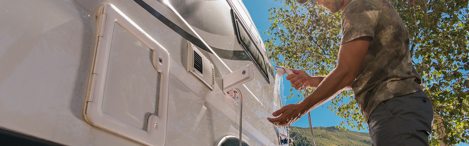 A camper with a water faucet, representing low water pressure issues and the need for solutions.
