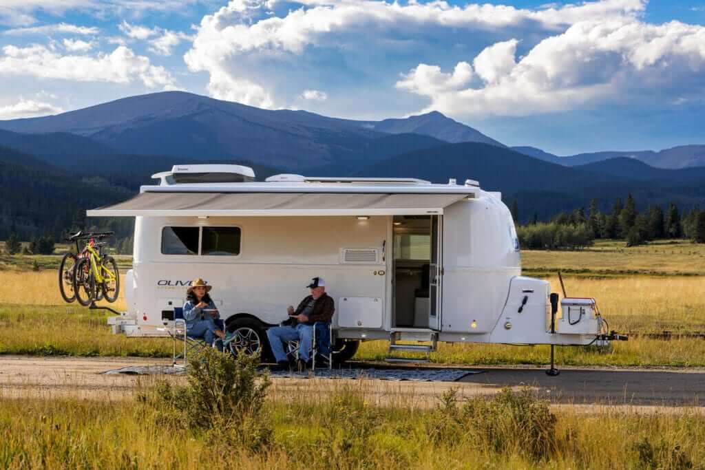 The exterior of the camper is sleek and aerodynamic, featuring durable fiberglass that is lightweight and easy to tow.