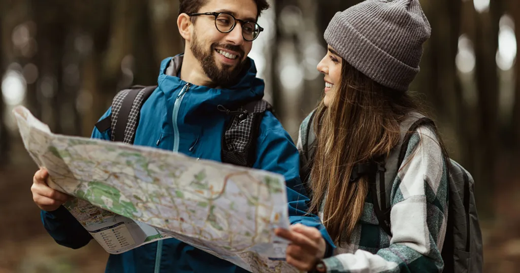 a couple joyfully planning their trip with map in hand