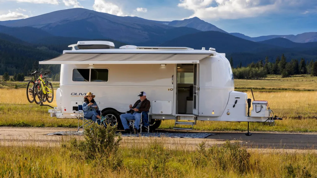 The exterior of the camper is sleek and aerodynamic, featuring durable fiberglass that is lightweight and easy to tow.