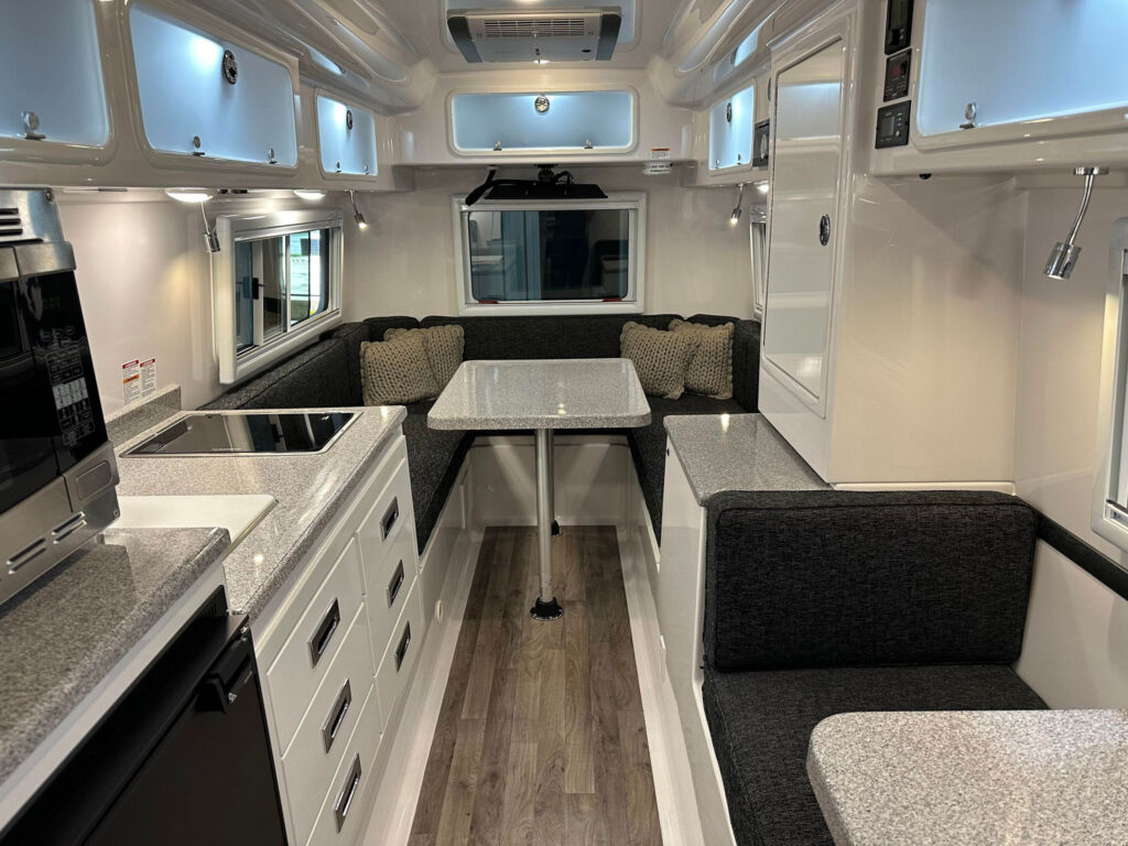 The 2024 Legacy Elite II 23 foot trailer is perfect for long stays. It features a durable composite hull construction and a spacious interior made of molded fiberglass, ideal for extended journeys.