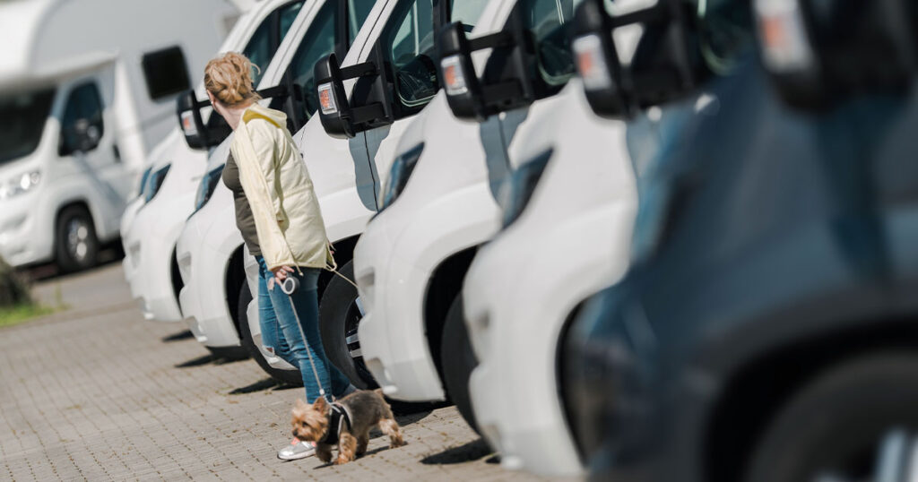 A woman looking at travel trailers for sale