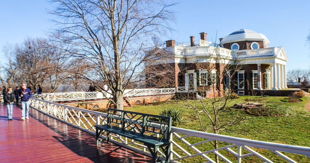 Charlottesville, Virginia: A historic town square with colonial architecture, surrounded by rolling hills and vineyards.