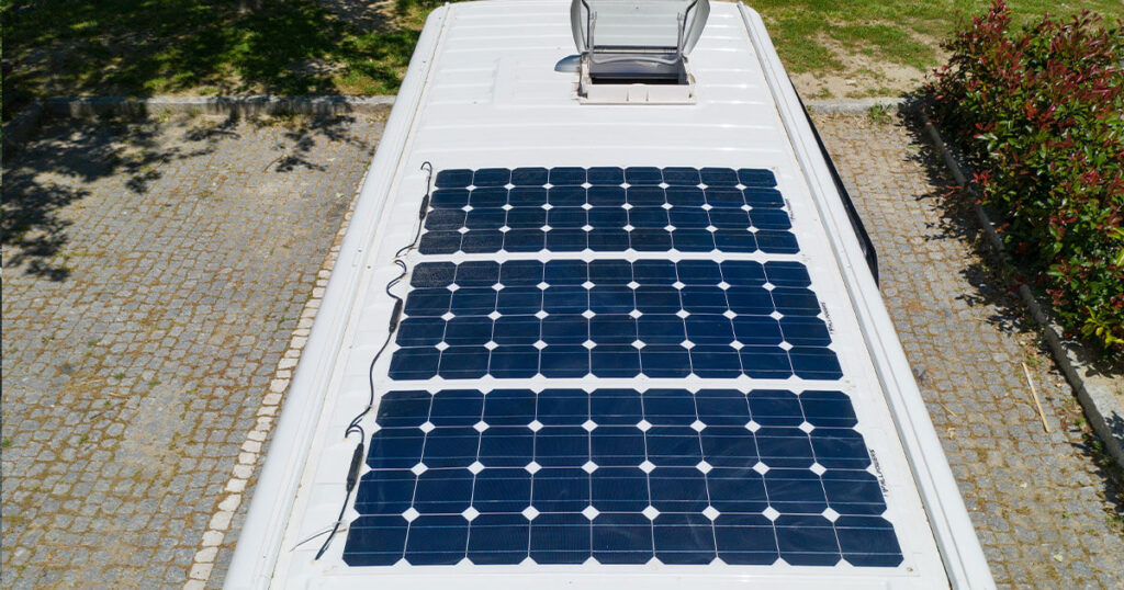 Inspecting the roof of a travel trailer for leaks and damage, a key step in 2025 maintenance tips for RVs.