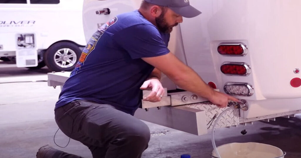 Cleaning and sanitizing water tanks in a travel trailer, essential for DIY maintenance checklists in 2025.