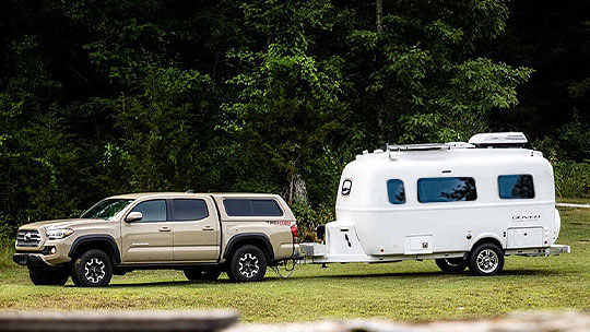 Oliver Travel Trailer off-grid setup with large water tanks, LED lighting, robust battery bank, and optional solar panels for extended, comfortable adventures.