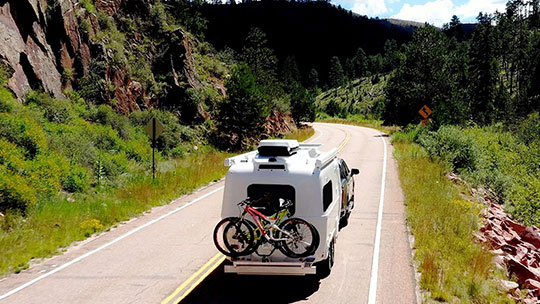 Oliver Travel Trailer with curved corners, sleek sides, and enclosed underside for aerodynamic design and fuel-efficient towing.