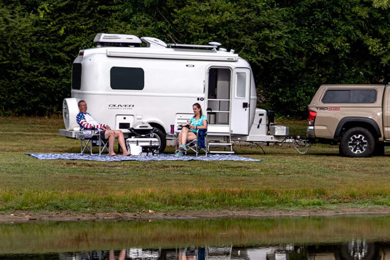 Lightweight Legacy Elite small camper designed for couples, parked outdoors.