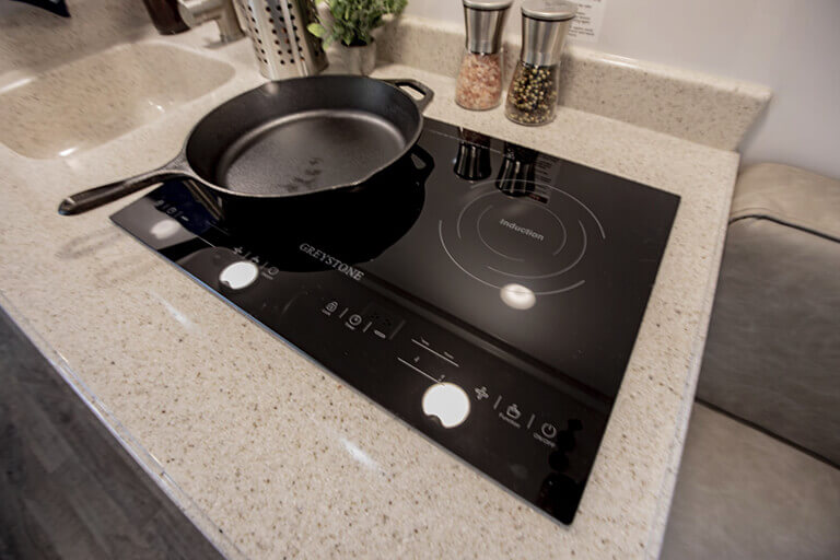 Oliver travel trailer cooktop in action