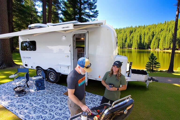 Couple enjoying Oliver travel trailer adventure